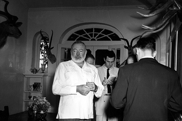 American novelist Ernest Hemingway meets the press at his Cuban home in San Francisco de Paula, a suburb of Havana, October 28, 1954, after announcement was made that he is awarded the 1954 Nobel Prize in literature. Hemingway said he "broke the training" and took a drink to celebrate the honor.