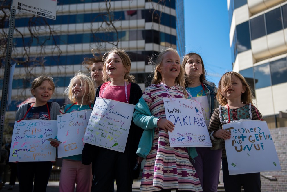 Holding homemade signs, young students from Glenview Elementary School chanted as the march passed by: "Get up! Get down! Oakland is a union town!"