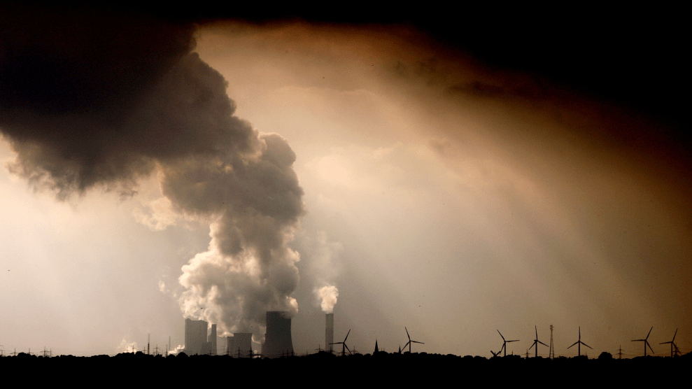 A power station spews huge fumes into a darkened sky.