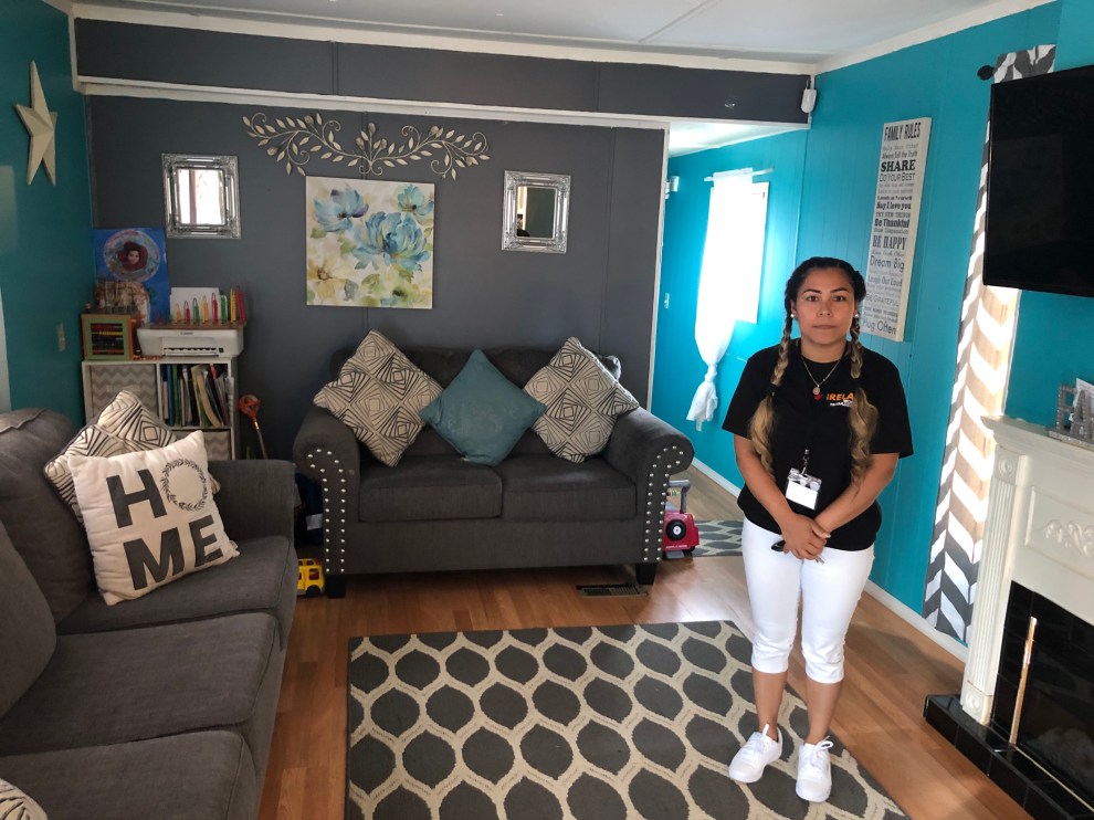 Patty Flores stands inside her mobile home in 2022. She feared that mold there had caused her son's respiratory problems.