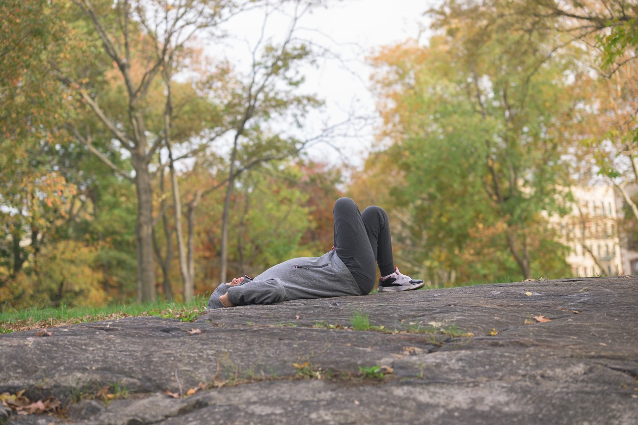 Cristobal lays down on a rock in the park near his home on a Saturday afternoon. He didn’t sleep much the night before after refusing to take his medicine, so he wanted to rest.