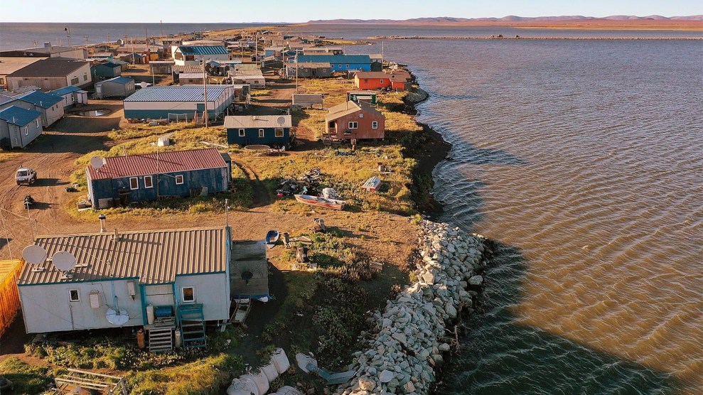 A handful of one story houses near a body of water