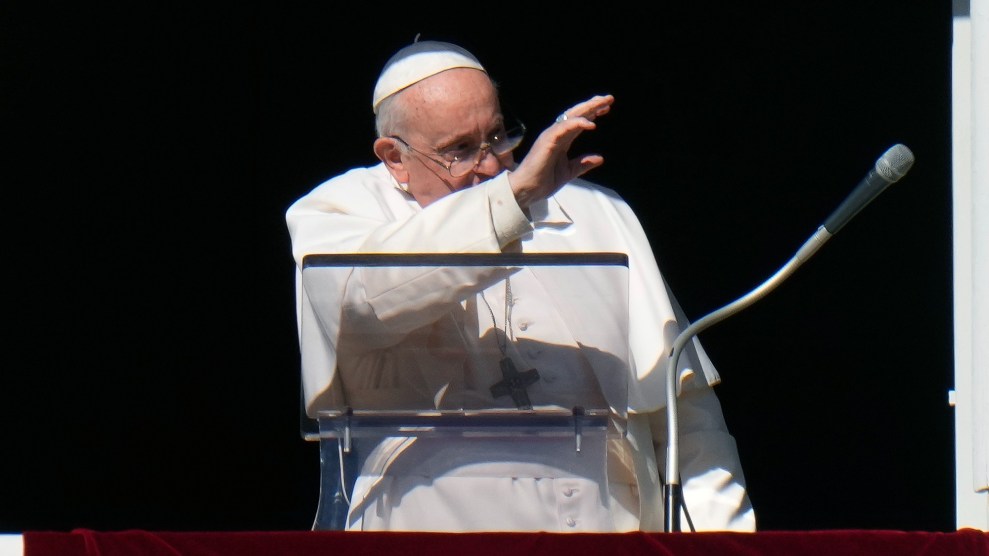 Pope Francis waves during the Angelus noon prayer from the window of his studio overlooking St.Peter's Square, at the Vatican.