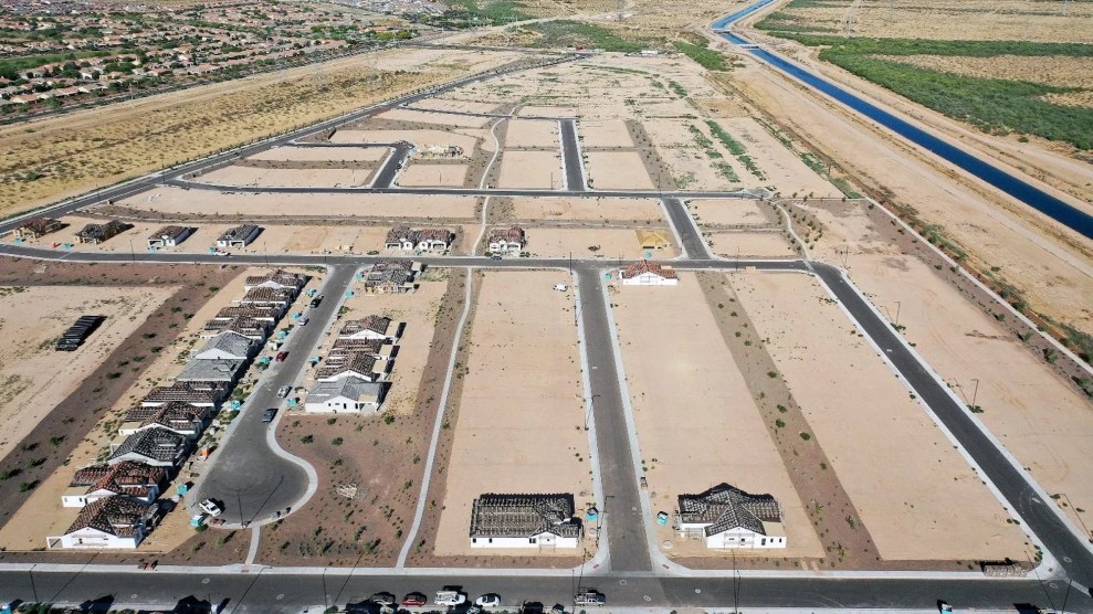 Aerial shot of some houses surrounded by a desert