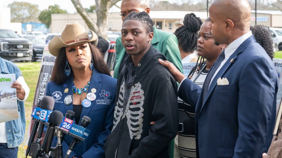 Dr. Candice Matthews, left, listens as state representative Ron Reynolds, right, with Darryl George, center, makes comments before a hearing regarding George's punishment for violating school dress code policy because of his hair style, Thursday Feb. 22, 2024 at the Chambers County Courthouse in Anahuac, Texas.