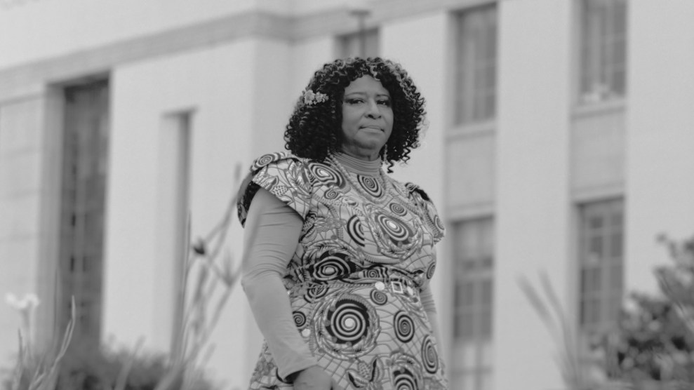 Black and white portrait of woman standing in front of a courthouse.