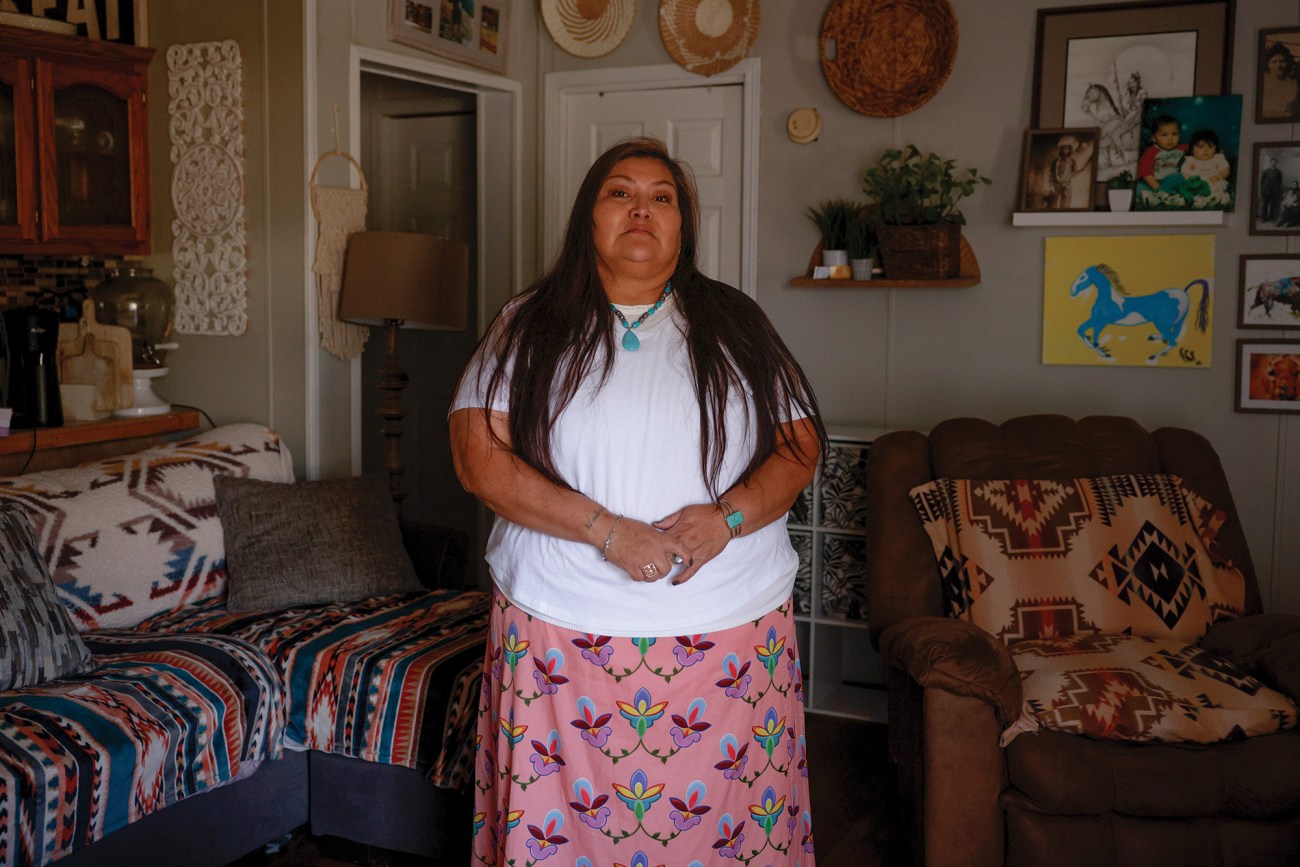 Portrait of woman standing in her home.