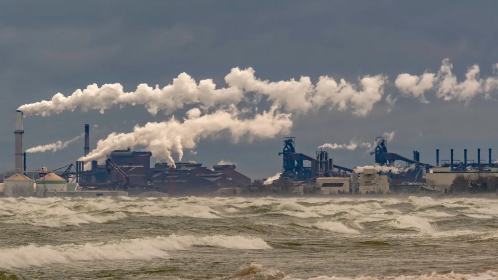 A steal mill with smoke surrounding it