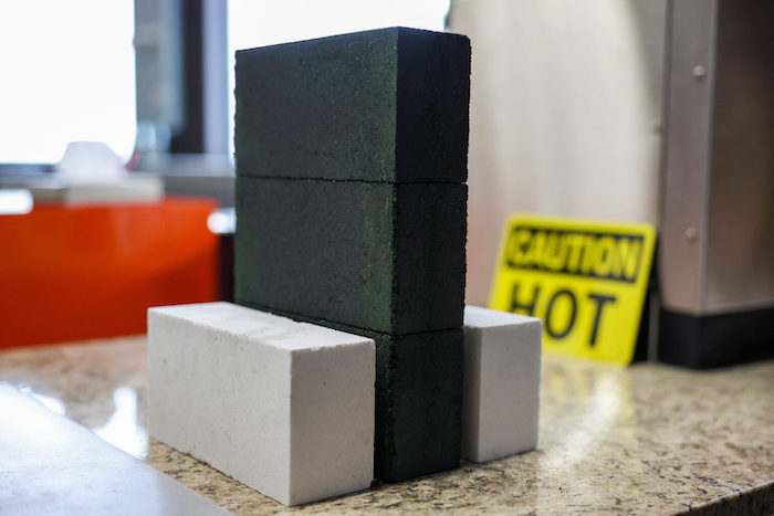 Gray and block bricks stacked on top of each other.
