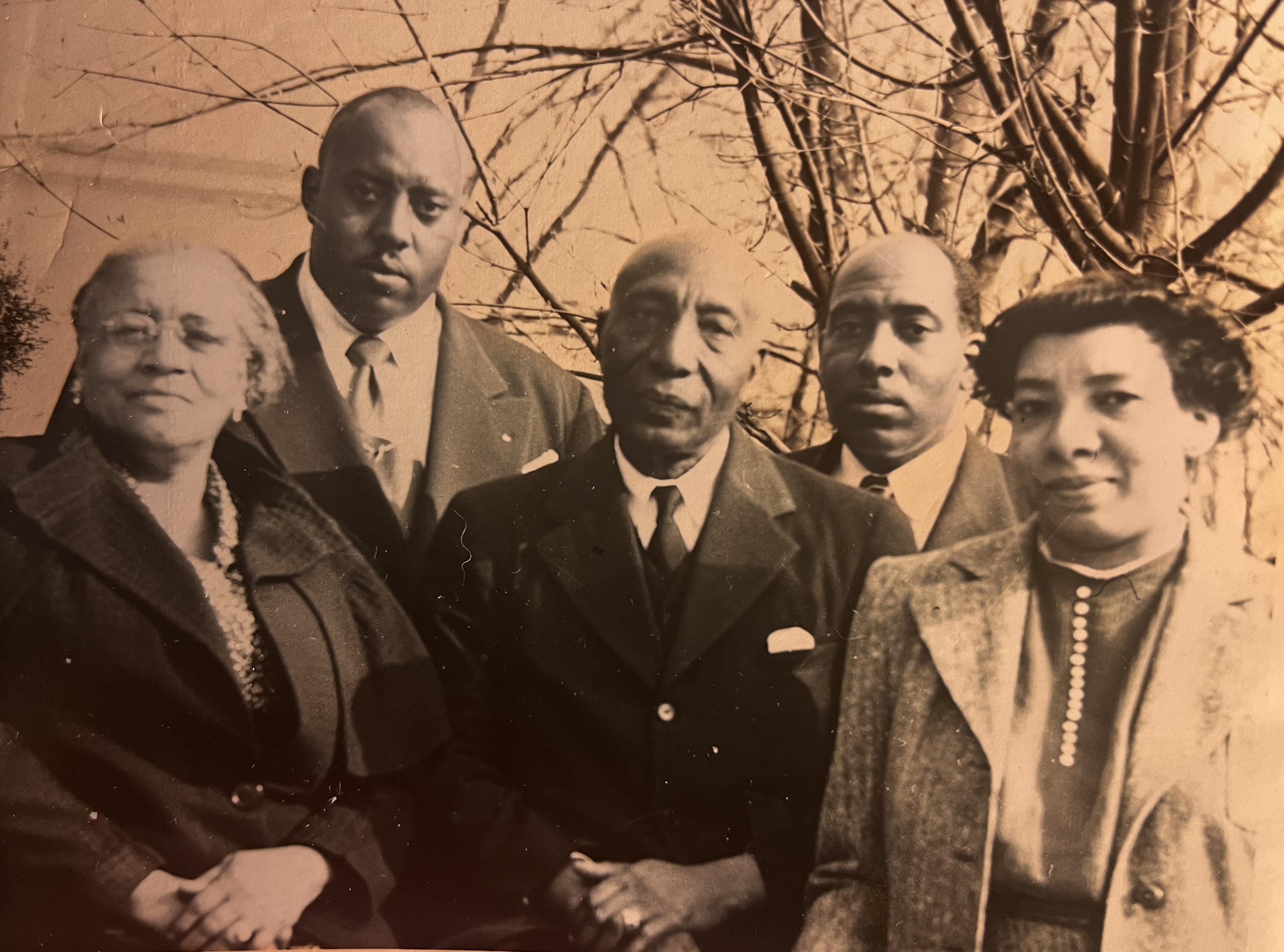 A sepia photo of a group of five people