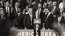 Donald Trump at the RNC is cheered on by surrounding family and supporters.