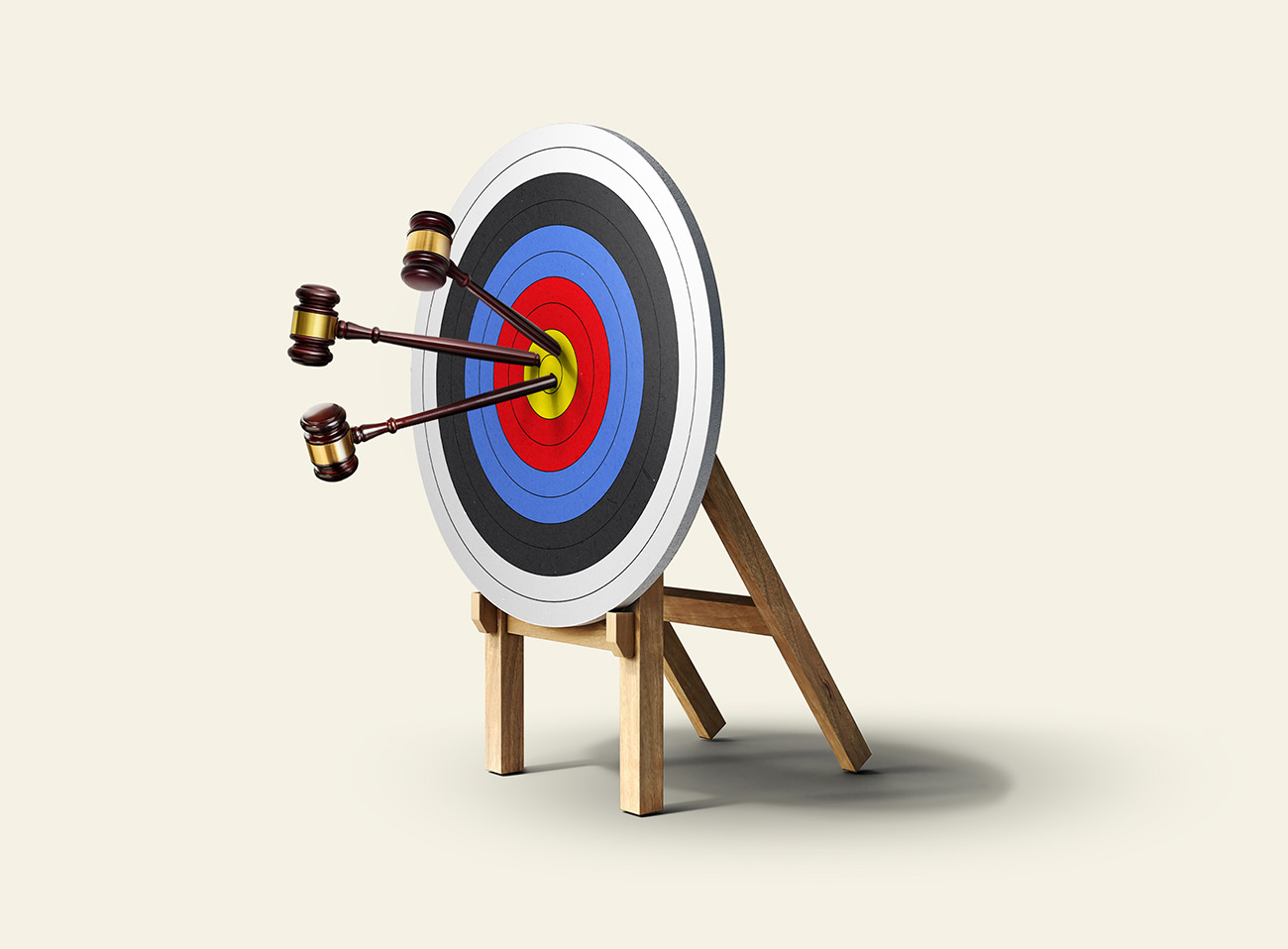 An archery target with arrows stuck in it near the middle. Instead of regular arrows, what is stuck in the target are judge's gavels.