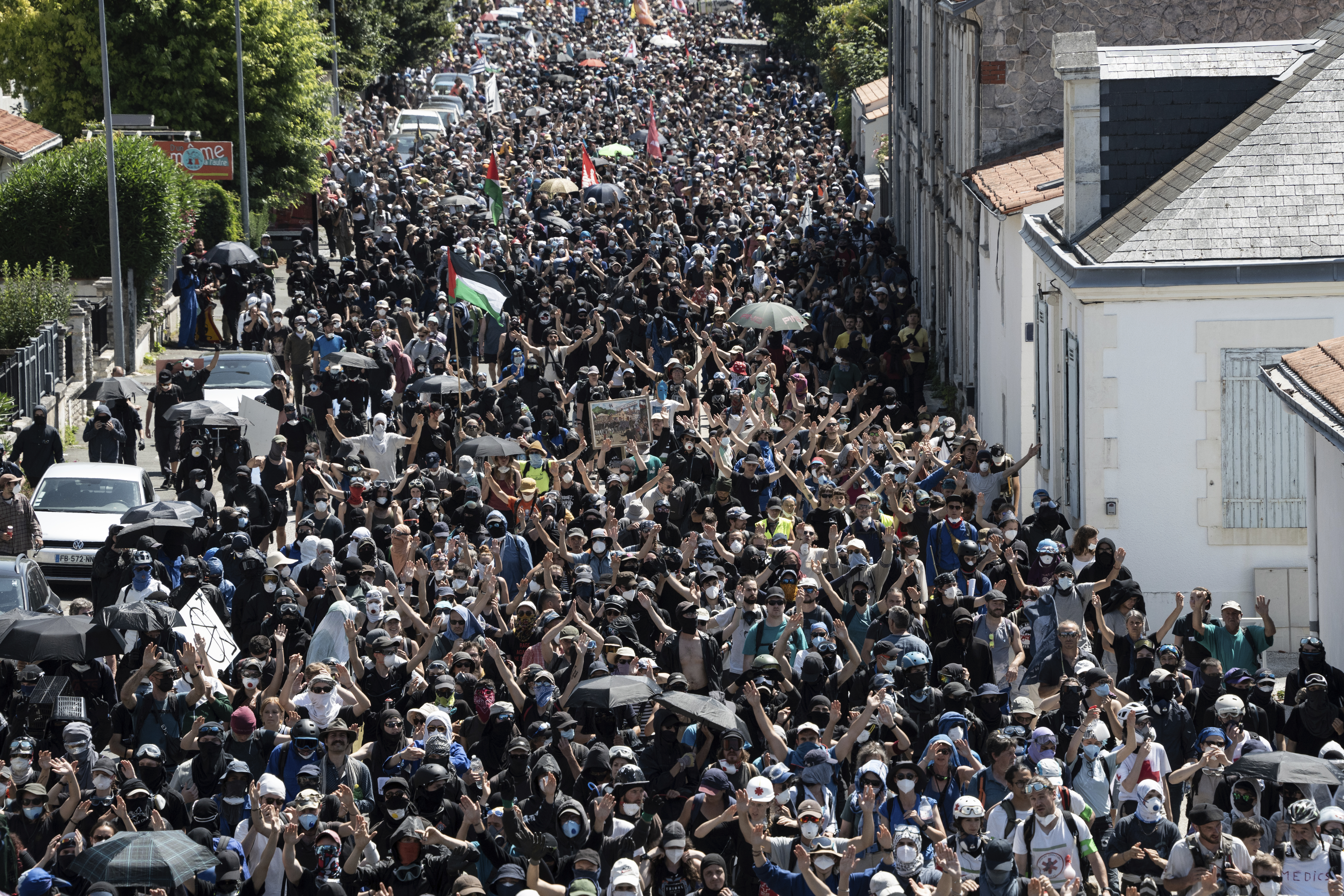 A group of protestors in France walking in a village demonstrating against giant water reservoirs.