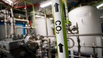 A pipe labeled CO2 pumps carbon byproduct in a production room in New York.