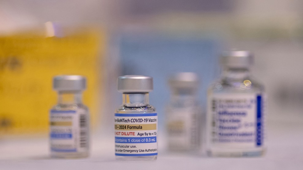 Vials of Pfizer Covid-19 vaccines resting on a white table