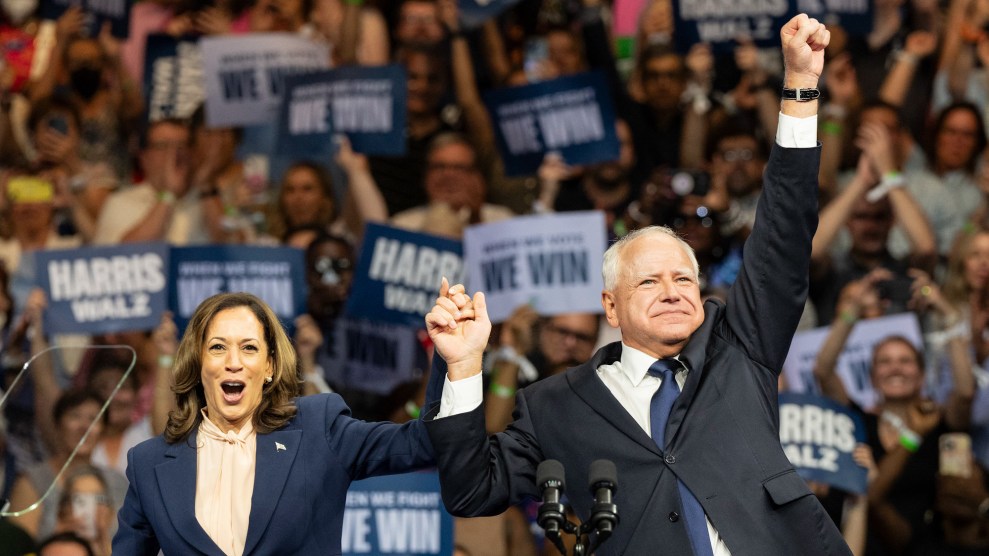 Harris and Walz holding hands and the other hand from Walz is raised in the air