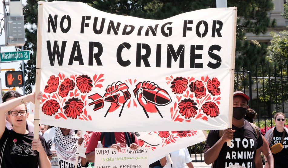 "No funding for war crimes" banner