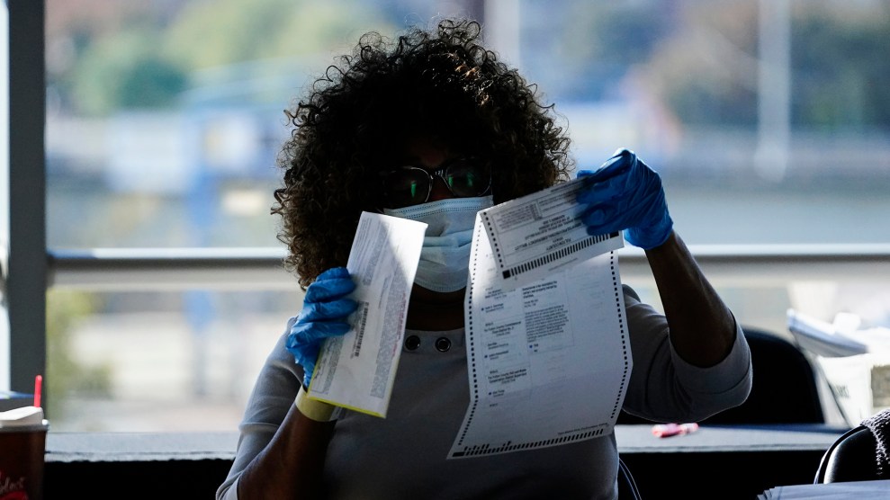 Woman holding up a ballot to inspect it.