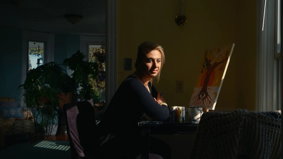 Portrait of person sitting in front of a painting.