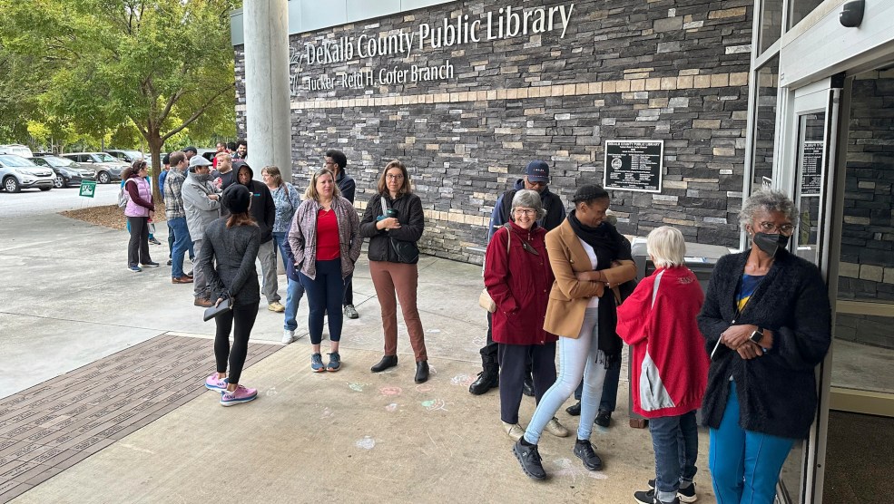 A photo of voters waiting in line to cast ballots.