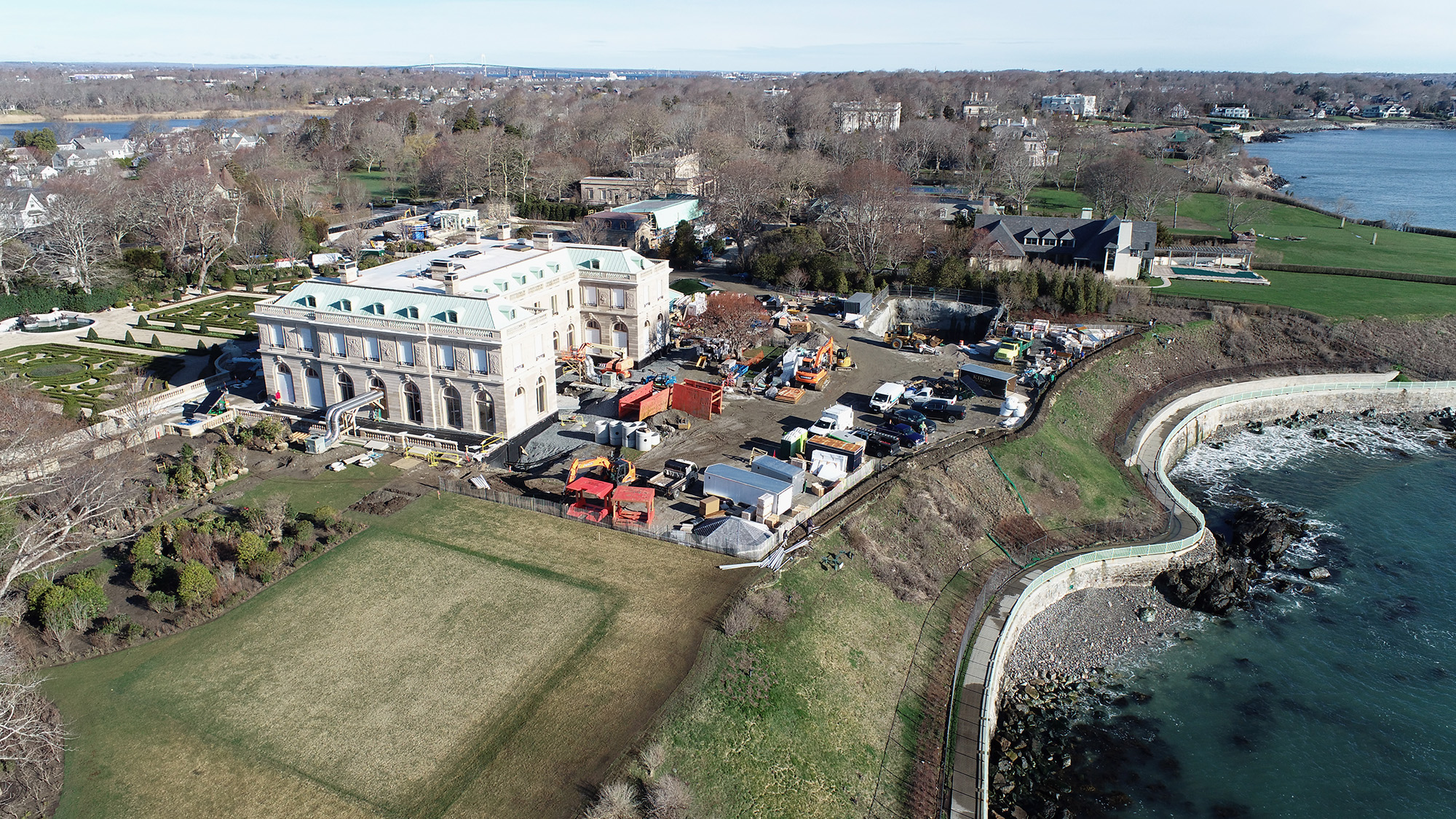 Overhead drone photo of a mansion with heavy construction happening around it.