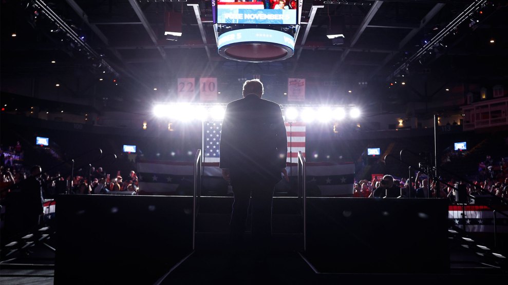 Donald Trump from behind, walking up stairs onto a stage