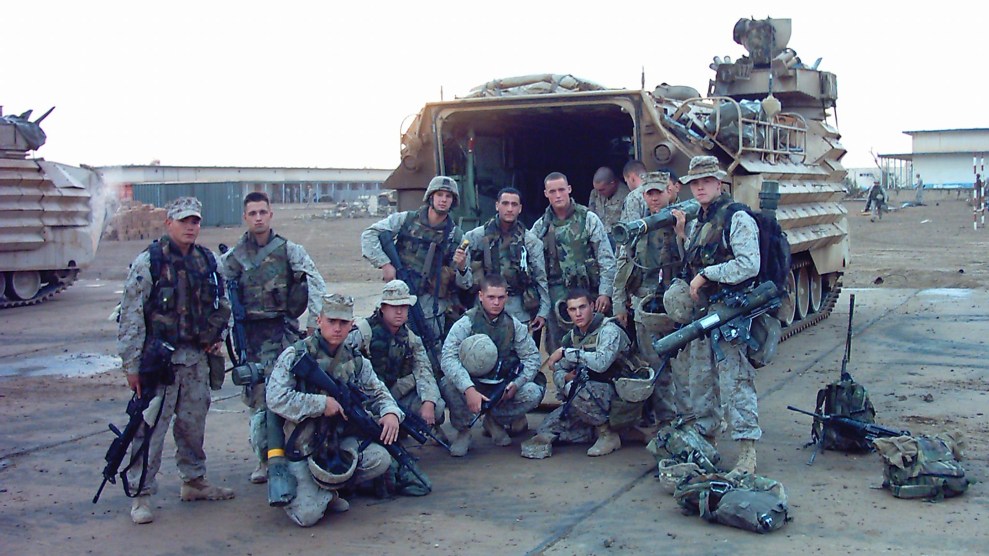 Marines posed around an armored personnel carrier.