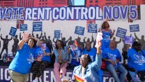 A group of nine people on a parade float holding up "Yes on 33" signs.