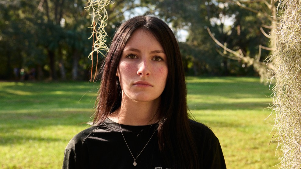 Portrait of woman outside, looking straight ahead.