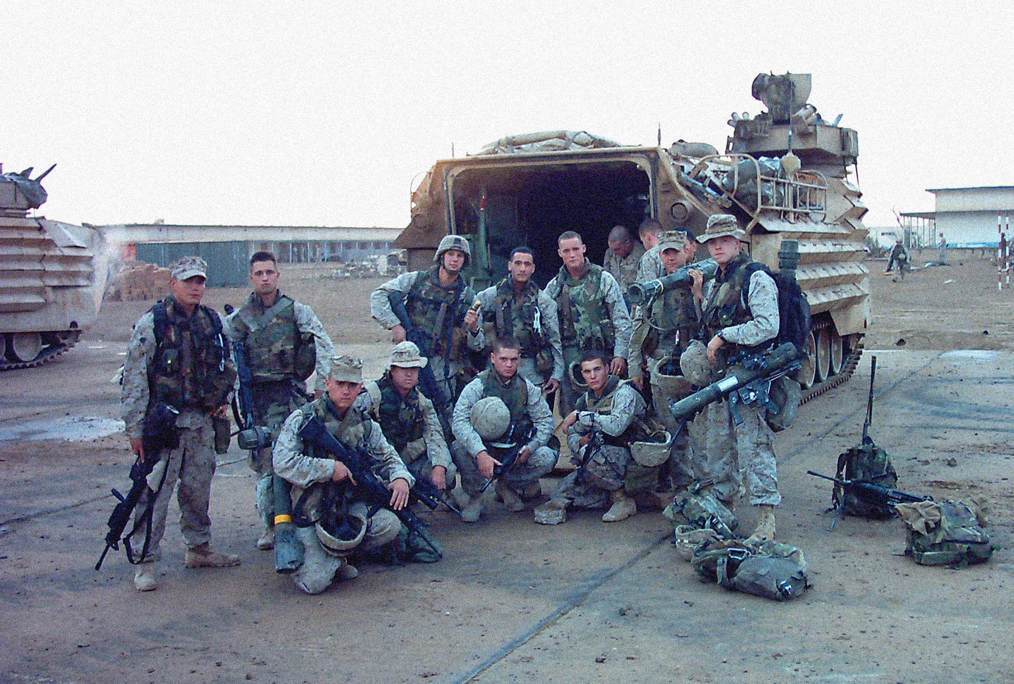 Marines posed around an armored personnel carrier.