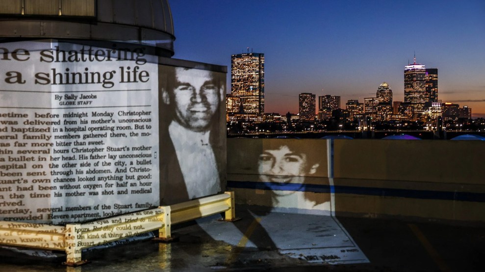 An image from a newspaper article about the death of Carol Stuart is projected on to the Boston skyline at night