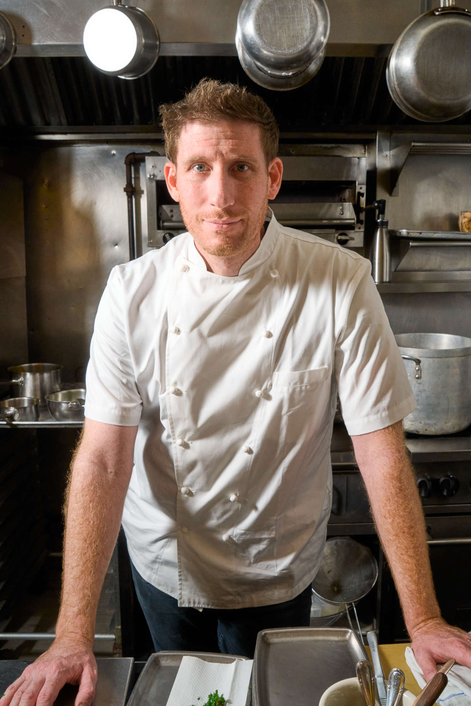 A white man in a chef's uniform.