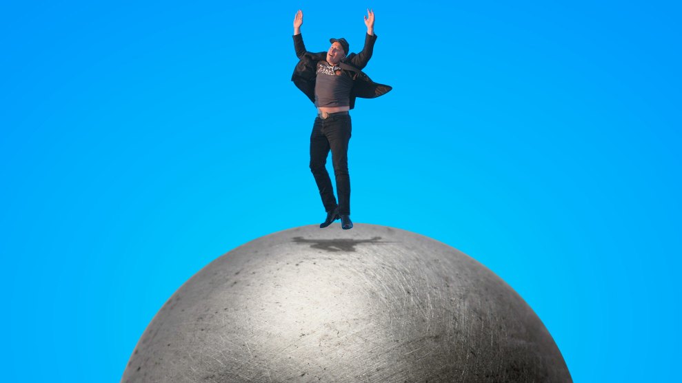 Elon Musk jumping up in celebration on a metal dome