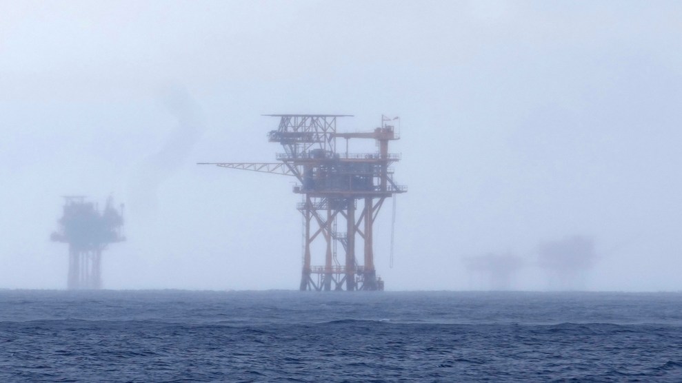 A foggy ocean with a structure in the distance.