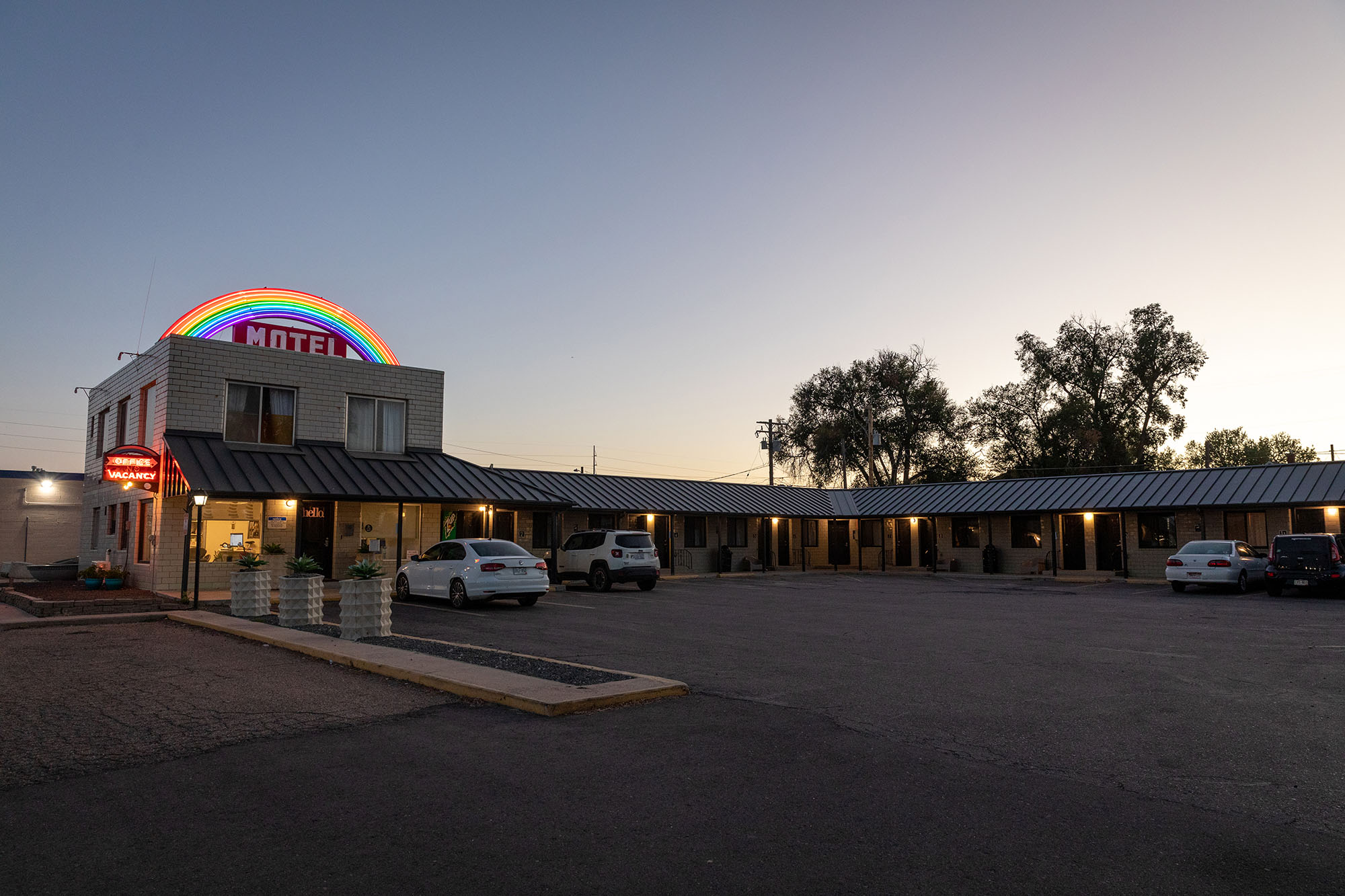 Motel with a neon rainbow over the "motel" sign.