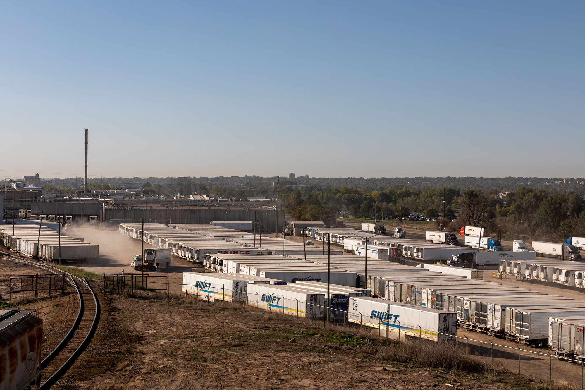 Landscape view of a parking lot full of semitrailers.