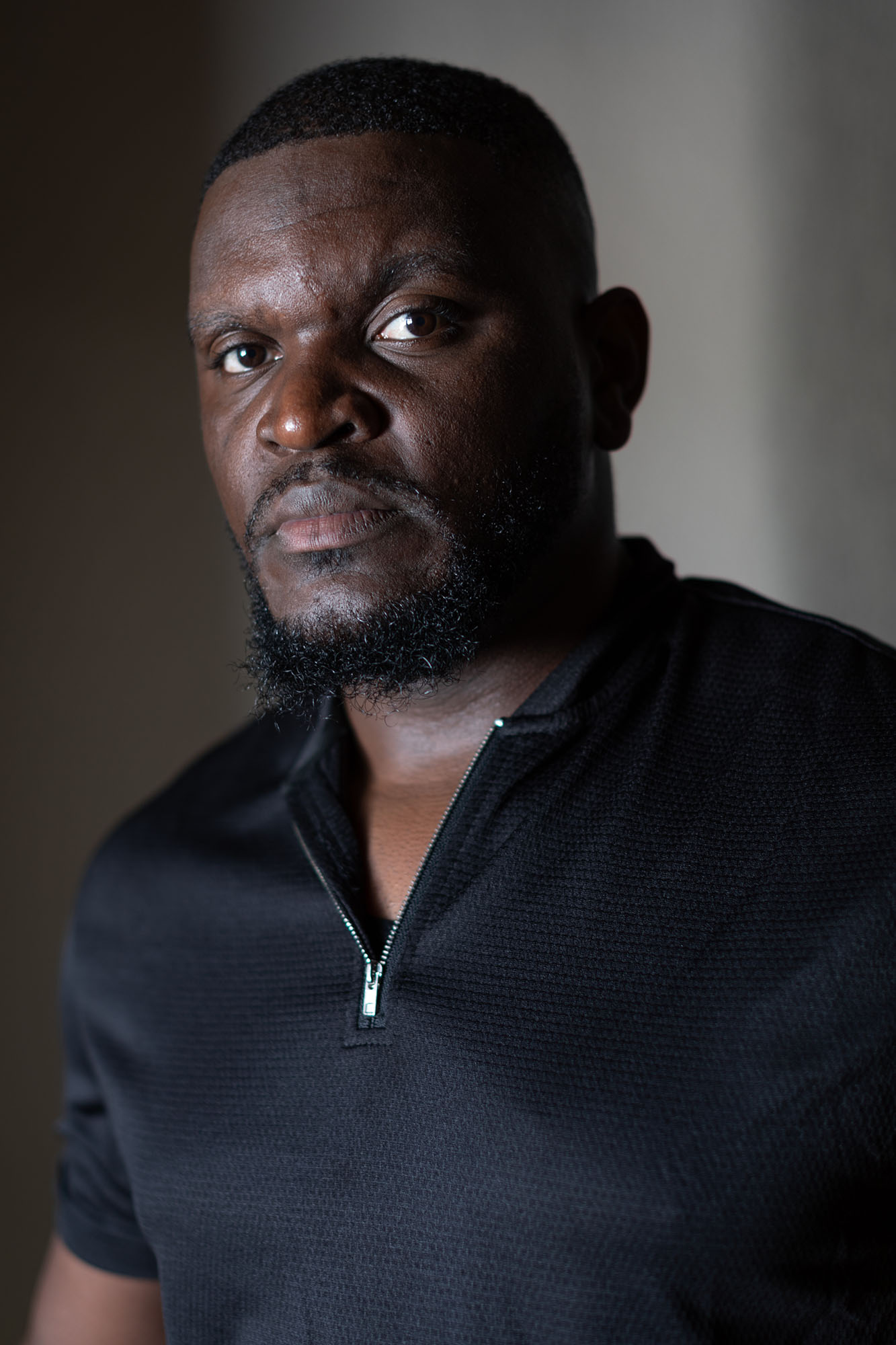 Portrait of a man in a black shirt.