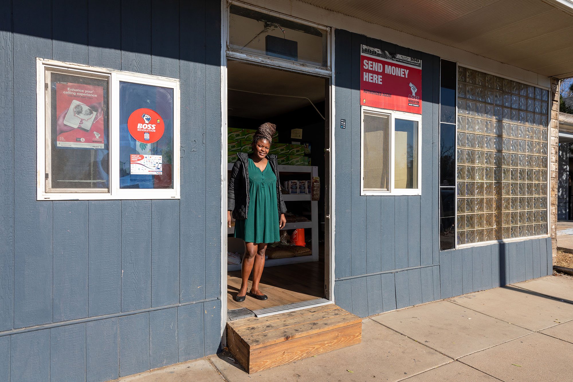 Woman standing in doorway of a building.