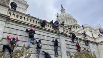 Trump supporters scale the US Capitol.