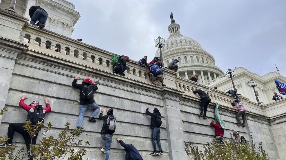 Trump supporters scale the US Capitol.