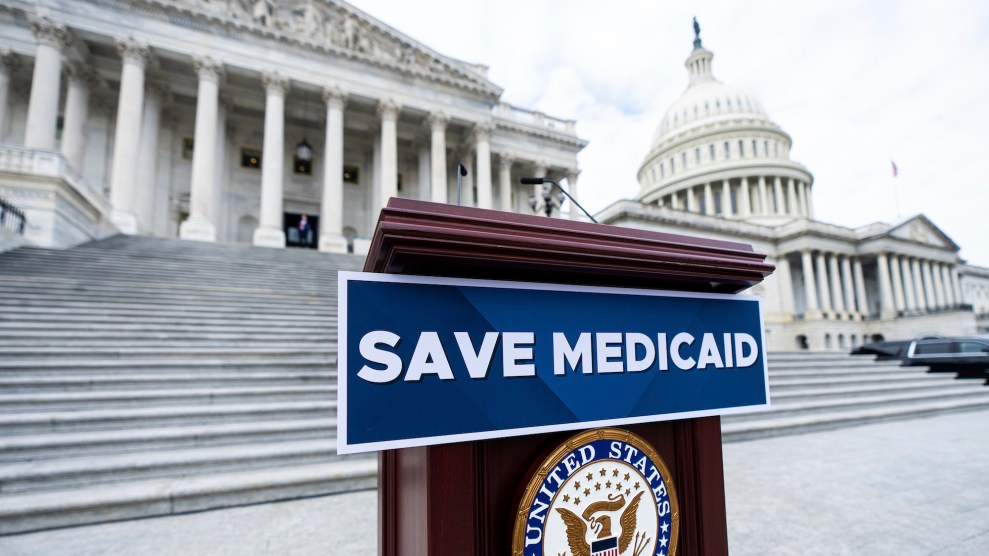 A podium with a sign that says "Save Medicaid" on it in front of a Congress building