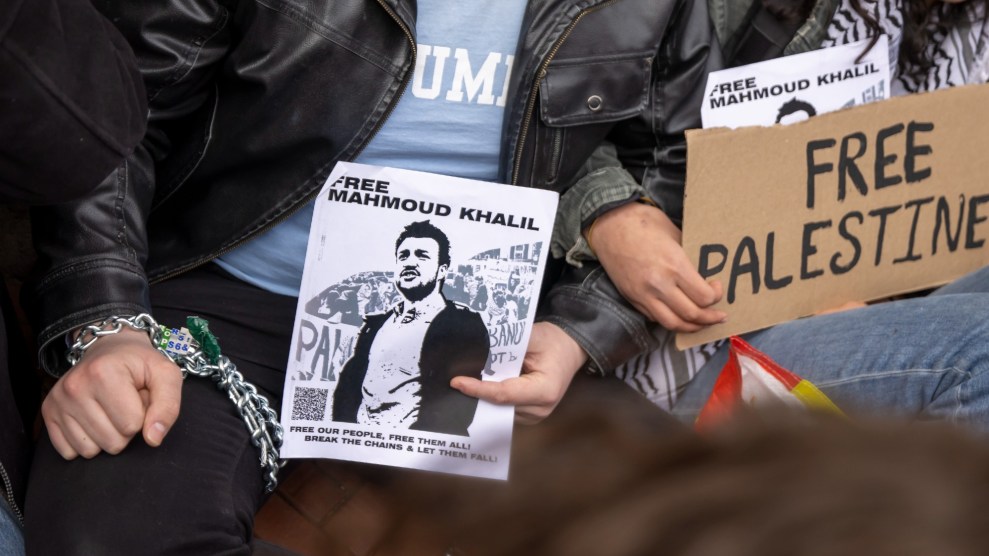 Students chained to Columbia's gates hold signs reading "Free Mahmoud Khalil" and "Free Palestine"