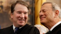 Close up image of U.S. Supreme Court Associate Justice Brett Kavanaugh laughing with Chief Justice John Roberts