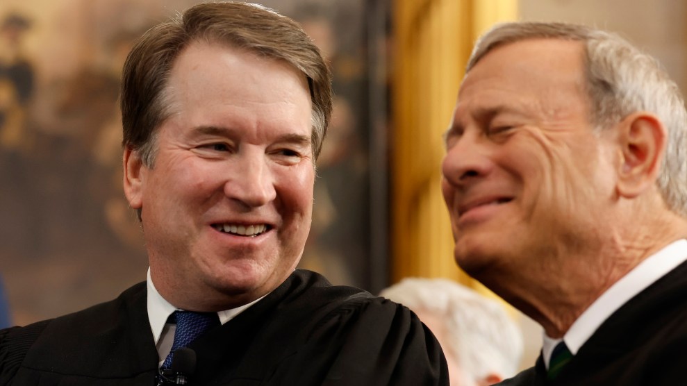 Close up image of U.S. Supreme Court Associate Justice Brett Kavanaugh laughing with Chief Justice John Roberts