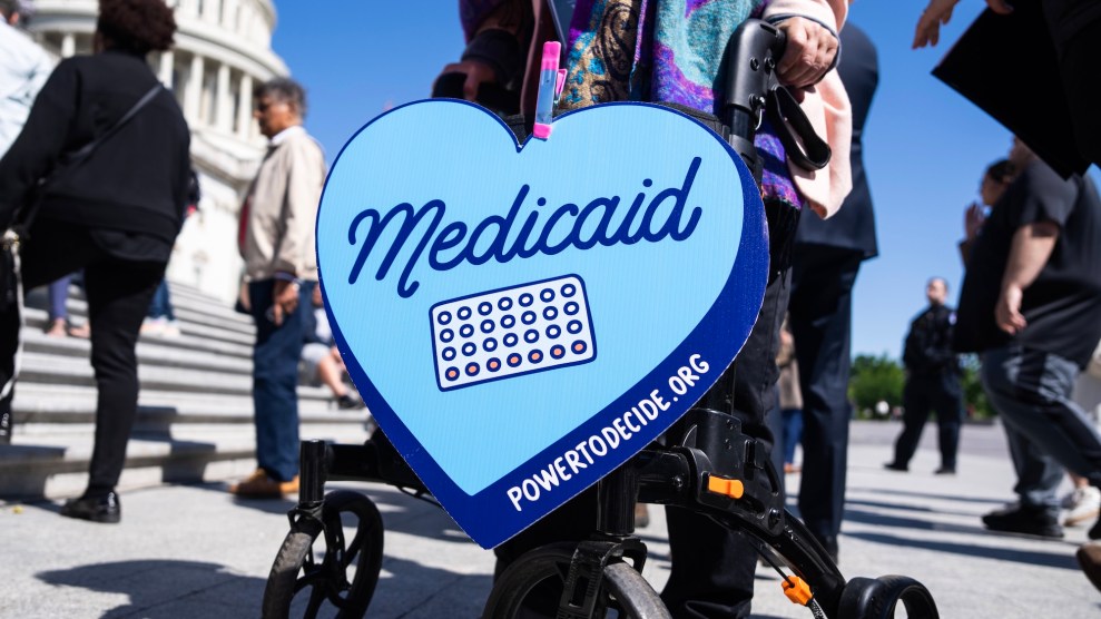 A black walker with a sign in the shape of a heart with the text Medicaid on it with some medication.