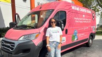 Woman in sunglasses standing next to a van that reads "Miami Diaper Bank"