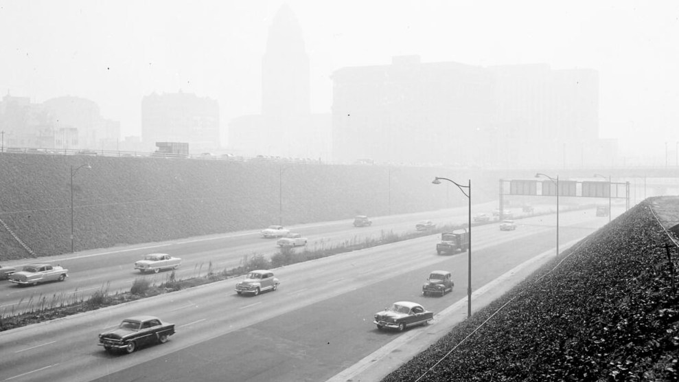 A picture of cars driving on the highway as smog covers Los Angeles