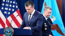 Defense Secretary Pete Hegseth standing at a podium.