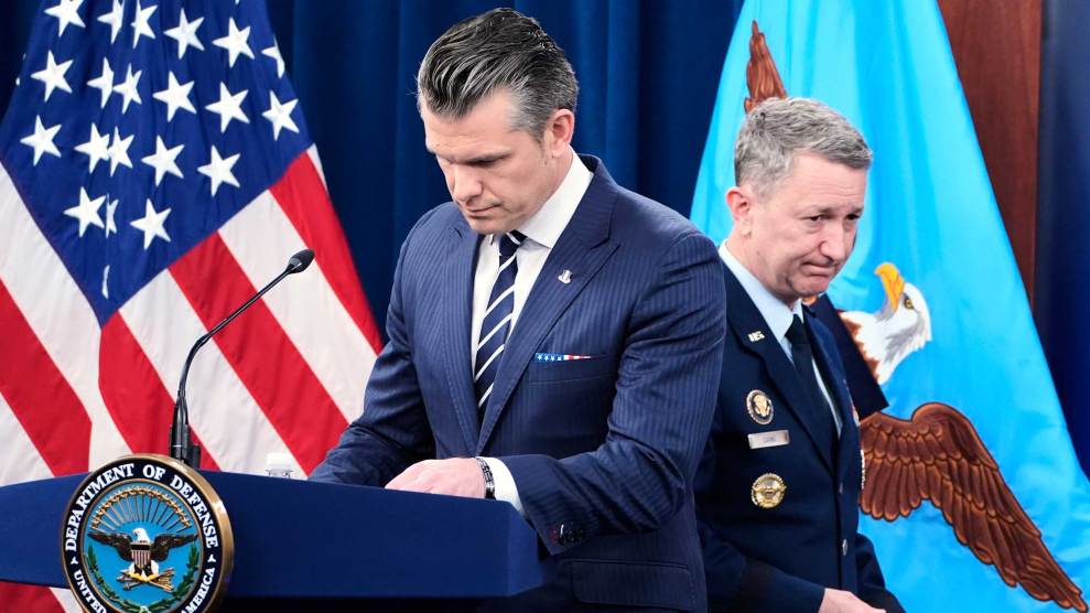 Defense Secretary Pete Hegseth standing at a podium.