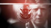 A photo illustration of a close-up photo of Donald Trump reaching out his hand toward the seal of the U.S. Department of Homeland Security. The image is blurry, grainy and has a red gradient.